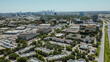 Business park group of office buildings, hotels, restaurants in Love Field neighborhood with downtown Dallas in background, sunny clear blue sky, busy traffic on Stemmons Freeway I35, aerial view