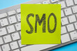Close-up of a keyboard with a sticker SMO social media optimization.