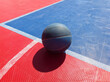 Basketball ball on a outdoor court.