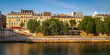 Paris buildings on a Summer morning along the River Seine (UNESCO World Heritage site). Sunlight bathes the historic buildings of the Left Bank (5th Arrondissement) with poplar trees. France