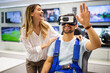 Couple enjoying with VR goggles at tech store. Shopping couple having fun at marketplace.