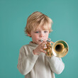 Portrait of little boy learning to play trumpet