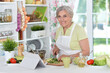 Portrait of a cute senior woman chef portrait at kitchen