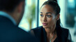 © The Yudel Media - A photograph of an African American woman engaging in a dynamic conversation with interviewers in a contemporary office setting.