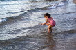 Girl playing in the water at the beach.