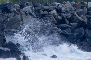 Wall Mural - Ocean waves crashing on a rocky shore