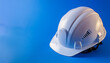 © hardvicore - Close-up of white construction helmet of blue background. Happy Labor Day concept. 1st May.