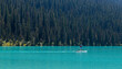 Stand up paddle boarding on the turquoise waters of Lake Louise, Banff national park, Canada.