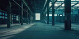 Fototapeta Uliczki - a large open space inside an empty and abandoned industrial warehouse