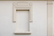 Elegant niche with classic pillars. Bricked up window. Architectural stucco detail of old European building. Chambranle, decorative ledge. Beautiful masonry facade decor in beige, white color. Nobody