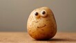 Smiling potato on a wooden table with copy space for your text