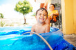 © kleberpicui - Happy child playing in inflatable home pool in summer. Active outdoor recreation.
