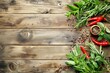 Herbs and spices on wooden background from above with space for text