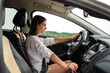 portrait of young woman driver at inside car