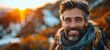 Smiling man with sunset and mountains. A portrait of a bearded man smiling at the camera with a sunset and mountainous landscape in the background, conveying a sense of adventure and happiness