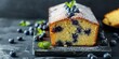 Freshly baked blueberry lemon pound cake dusted with powdered sugar, served with raw blueberries and mint.