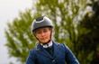 Portrait of a beautiful young woman preparing before a horse riding competition