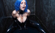woman with blue hair and large breasts is in a pool of water, wearing a black catsuit.
