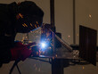 Competitions among welders. A man in a protective mask is welding.