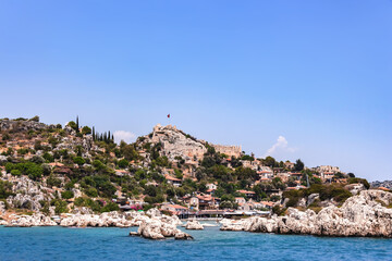 Simena Castle overlooking the serene blue waters of the Turkish Riviera, a historic and vivid haven. Demre, Antalya, Turkey (Turkiye)