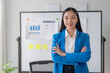 Portrait of Asian businesswoman in the office. Crossed arms. Confident Asian Businesswoman Standing in Office,