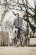Man Standing Next to Bicycle During Commuting