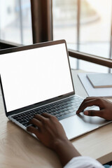 Canvas Print - Business person working online or learning using laptop mock up blank white empty screen, hands typing on computer background close up view. Mockup display for ads. Close up view.