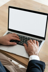 Canvas Print - Business person working online or learning using laptop mock up blank white empty screen, hands typing on computer background close up view. Mockup display for ads. Close up view.