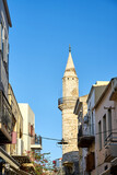 Fototapeta  - narrow street and historic minaret in the town of Chania on the island of Crete