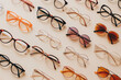 © Татьяна Евдокимова - Collection of fashionable eyeglasses and sunglasses arranged neatly on a minimalist backdrop