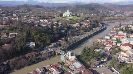 Wall Mural - View from drone of historical districts of old Georgian city of Kutaisi on both sides of Rioni river with rebuilt building of Cathedral