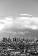 Skyline of downtown Los Angeles, California (USA) on a cloudy spring afternoon seen from Griffith Observartory viewpoint. Hollywood panorama with dramatic cloudscape, skycrapers. Black and white.