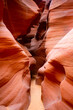 Narrow slot canyon in Arizona (USA), a natural wonder and magic place formed by the power of erosion. Red-orange sandstone washed out by water. Colorul shapes illuminated by sun. Tourist attraction.