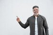 © Stock 4 You - Smiling mature 40s old businessman with grey hair beard in casual shirt, pointing at copy space for promo advertising. Businessman standing gesturing hand isolated on white background, looking camera