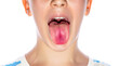 Little boy showing her tongue. Child puts out tongue - close up. Little boy sticks out his tounge. Child showing his tongue on white background, closeup. Health and medical concepts