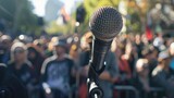 Fototapeta  - Emphasizing speech freedom: A speaker at a rally with mic on International Democracy Day. International Day of Democracy, September 15