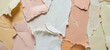 Torn grunge ripped pastel colorful paper background. Beige, ivory, yellow, peach colors ripped paper pieces collage