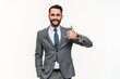 Positive young businessman showing thumb up isolated over white background. Approving gesture of Caucasian manager in formal suit. Agreement, quality deal sign