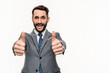 Cheerful young Caucasian manager showing thumbs up in camera isolated over white background. Successful deal, approval, content, agreement concept