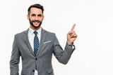Fototapeta  - Cheerful Caucasian manager in grey suit pointing at free space isolated over white background. Advertising concept, man showing copyspace blank space, promotion