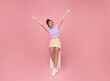 Attractive Asian teen girl sitting on chair and relax hand up isolated on pink background. People lifestyle concept.