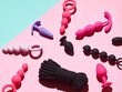sex toys background. anal plugs and dildo over pink backdrop