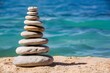 Soothing scene of balanced stacked stones on a sandy beach by azure waters