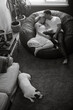 © Dina Marie Giangregorio/Stocksy - Loving Couple on Beanbag holding Newborn Baby