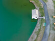 Top down view of small cabin in the middle of green water pond in Ohio countryside.