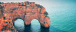 Two arches in the rock. Rock Elephant drinks water. View of Praia da Marinha and Benagil beach in the Algarve region of the Atlantic Ocean, Portugal. Horizontal banner