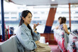 Woman use mobile phone for sending audio message on ferry