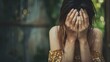© Pascal - Depressed young woman covering her face with her hands. Photo of a Young Woman Coping with Distress by Covering Her Face. mental health concept.
