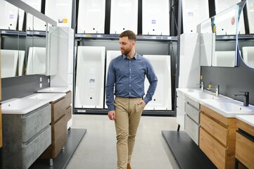 Wall Mural - Man choosing new bathroom furniture at the plumbing shop with lots of sanitary goods