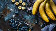 composition with fresh ripe bananas and blueberry on color table